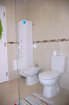 a bathroom with a toilet and a sink at Lovely 1 Bedroom apartment in Praia da Luz in Luz