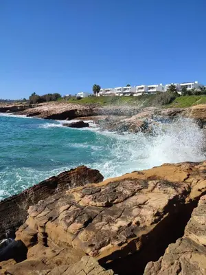 a view of the ocean from a rocky beach at Lovely 1 Bedroom apartment in Praia da Luz in Luz