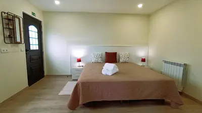 a bedroom with a large bed and a window at A Toca in Santana
