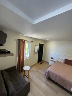 a bedroom with a bed and a couch at A Toca in Santana