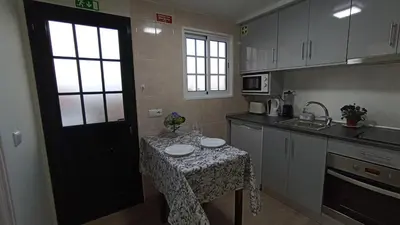 a kitchen with a table with a table cloth on it at A Toca in Santana