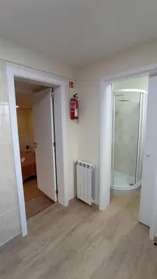an empty room with a mirror and a radiator at A Toca in Santana