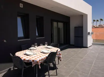 a table with a checkered table cloth on a patio at Sunset House in Vila do Bispo