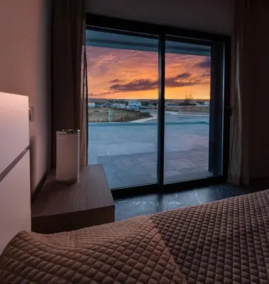 a bedroom with a bed and a window with a view at Sunset House in Vila do Bispo