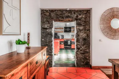 a kitchen with a stone wall at Meerblick - 3-Bett Villa mit Terrassen & Hot-Tub in Fajã da Ovelha