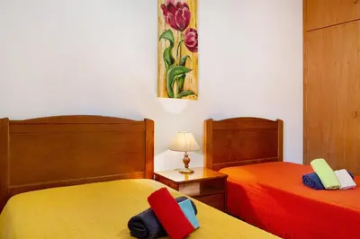 two beds sitting next to each other in a room at Cantinho Solpraia in Porto Santo