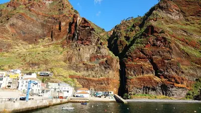 a view of a mountain next to a body of water at Blue by the Sea House in Paul do Mar