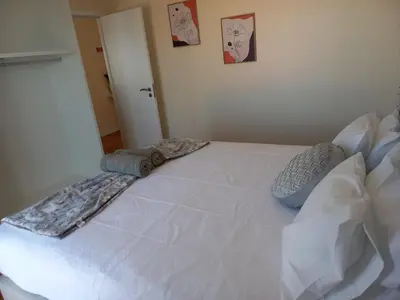 a white bed with two pillows on top of it at Casa Dos Ramos in Arco da Calheta