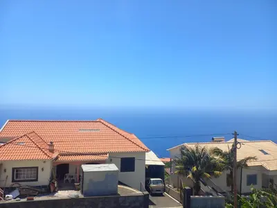a group of houses with the ocean in the background at Casa Dos Ramos in Arco da Calheta