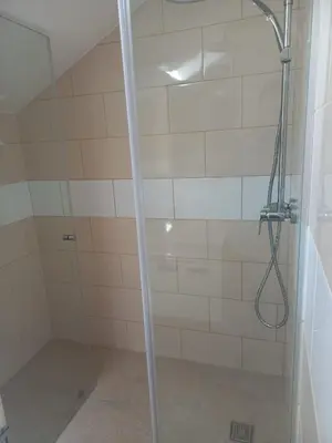 a shower with a glass door in a bathroom at Casa Dos Ramos in Arco da Calheta