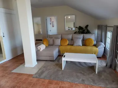 a living room with a couch and a table at Casa Dos Ramos in Arco da Calheta