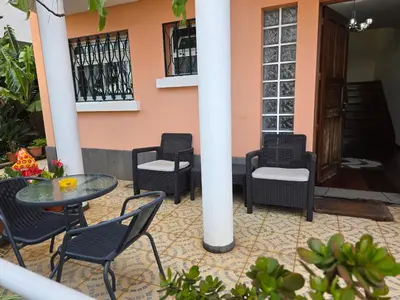 a patio with a table and chairs and a building at Casa de Feria do Livramento in Funchal