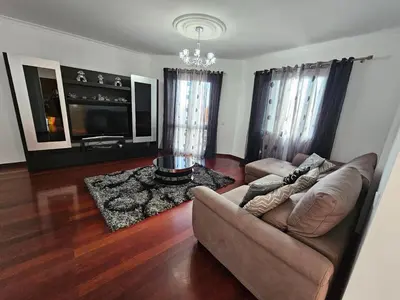 a living room with a couch and a tv at Casa de Feria do Livramento in Funchal
