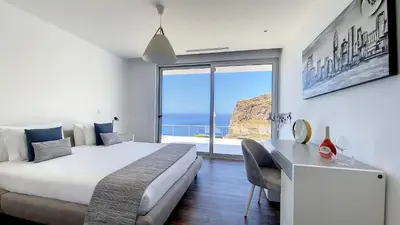 a bedroom with a large bed and a large window at Villa Blue Horizon by LovelyStay in Tábua
