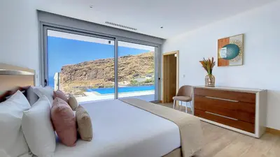 a bedroom with a bed and a desk and a large window at Villa Blue Horizon by LovelyStay in Tábua