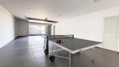 a ping pong table in the middle of a room at Villa Blue Horizon by LovelyStay in Tábua
