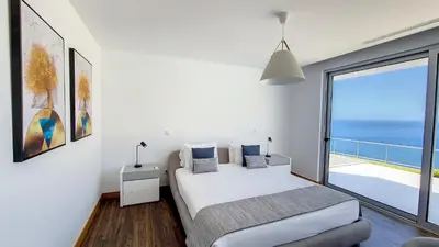 a bedroom with a bed and a view of the ocean at Villa Blue Horizon by LovelyStay in Tábua