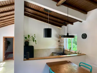 a kitchen with wooden ceilings and a wooden table at O Ninho in Atalaia