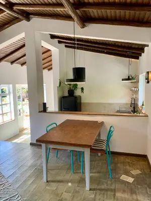 a kitchen with a table and chairs in a room at O Ninho in Atalaia