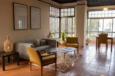 a living room with a couch and tables and chairs at Flag Hotel Madeira - Ribeira Brava in Ribeira Brava
