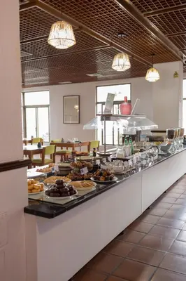 a buffet line with food on display in a restaurant at Flag Hotel Madeira - Ribeira Brava in Ribeira Brava