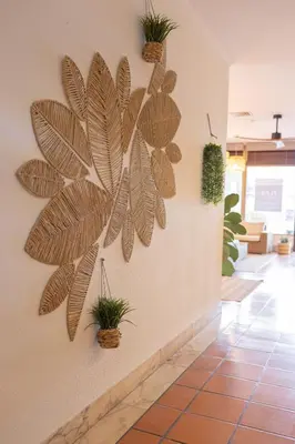 a wall decoration of a plant on a wall at Flag Hotel Madeira - Ribeira Brava in Ribeira Brava
