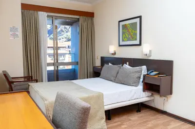 a hotel room with a bed and a window at Flag Hotel Madeira - Ribeira Brava in Ribeira Brava