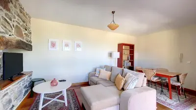 a living room with a couch and a tv at Bohome Nest by LovelyStay in Arco da Calheta