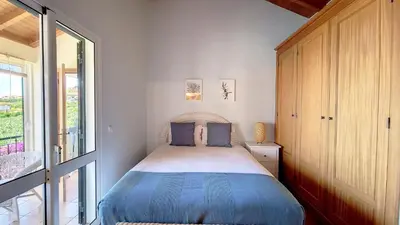 a bedroom with a bed and a large window at Bohome Nest by LovelyStay in Arco da Calheta
