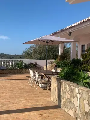 a living room with a table and a blue door at Quinta da Bela Vista in Lagos