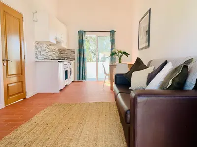 a balcony with a glass table and a view of a field at Quinta da Bela Vista in Lagos