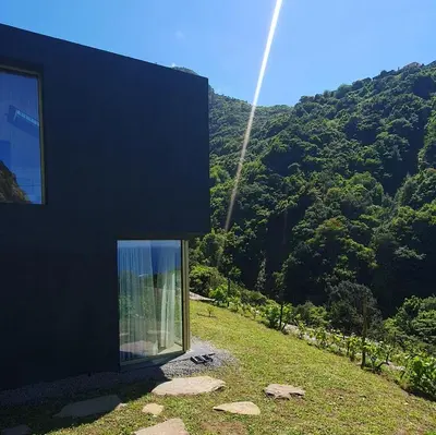 a black house with a view of a mountain at Terrabona Nature & Vineyards in Boaventura