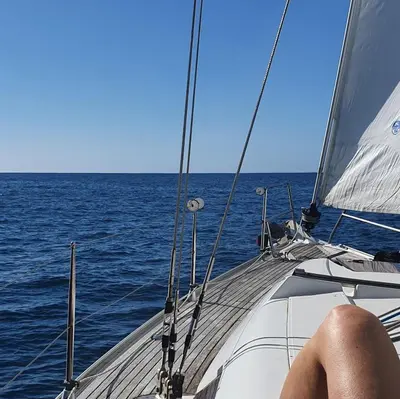 a person sitting on a sail boat in the ocean at Terrabona Nature & Vineyards in Boaventura