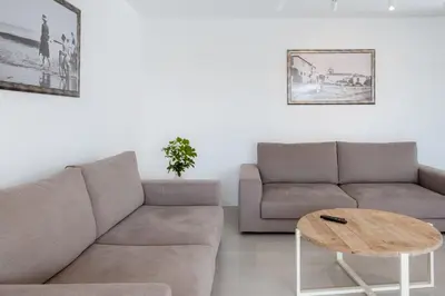 a living room with a couch and a table at GuestReady - A delightful stay in Porto Santo in Pontinhas