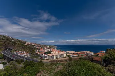 a town on a hill next to the ocean at GuestReady - A modern and peaceful stay in Santa Cruz