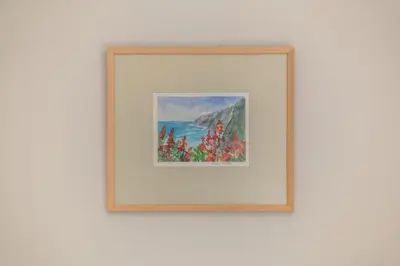 a framed picture of flowers on a wall at GuestReady - A modern and peaceful stay in Santa Cruz