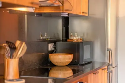 a kitchen with a television and a bowl on a counter at GuestReady - A modern and peaceful stay in Santa Cruz