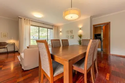 a dining room with a wooden table and chairs at GuestReady - A modern and peaceful stay in Santa Cruz