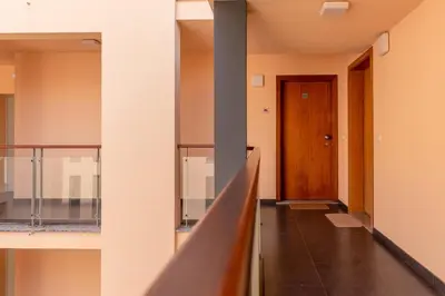 a hallway of a building with a wooden door at GuestReady - A modern and peaceful stay in Santa Cruz