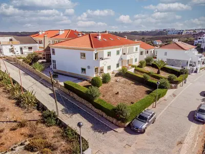 an aerial view of a house with cars parked in a driveway at Clifftop Nest Arrifana by Lisbeyond in Aljezur