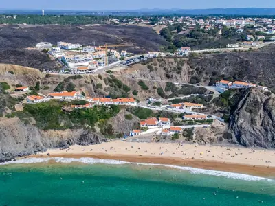 an aerial view of a beach and a town at Clifftop Nest Arrifana by Lisbeyond in Aljezur