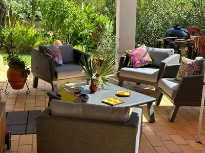 a patio with couches and a table and chairs at Villa Lagos Algarve for families & friends, 6 bedrooms, 7 bathrooms, pool, BBQ, central heating in Pedra Alçada