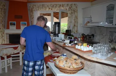 a man standing in a kitchen preparing food at Villa Lagos Algarve for families & friends, 6 bedrooms, 7 bathrooms, pool, BBQ, central heating in Pedra Alçada
