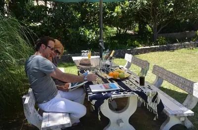two people sitting at a picnic table in a park at Villa Lagos Algarve for families & friends, 6 bedrooms, 7 bathrooms, pool, BBQ, central heating in Pedra Alçada