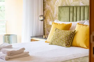 a bedroom with a bed with yellow pillows at Apartamento Vale Verde by Homie in Funchal