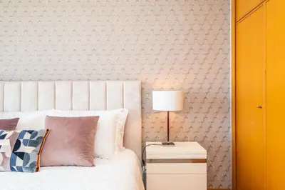 a bedroom with a bed and a lamp on a night stand at Apartamento Vale Verde by Homie in Funchal