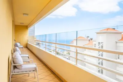 a balcony with chairs and a view of the ocean at Apartamento Vale Verde by Homie in Funchal