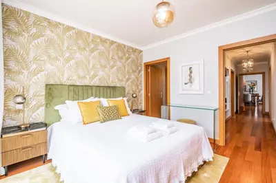 a bedroom with a white bed and a wall mural at Apartamento Vale Verde by Homie in Funchal
