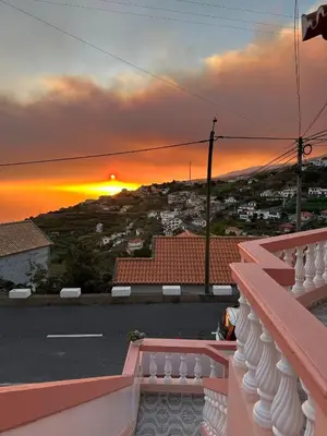 a view of a sunset from the balcony of a house at Blue Paradise Apartment in Ribeira Brava