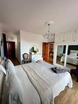 a bedroom with a large bed with a large mirror at Blue Paradise Apartment in Ribeira Brava